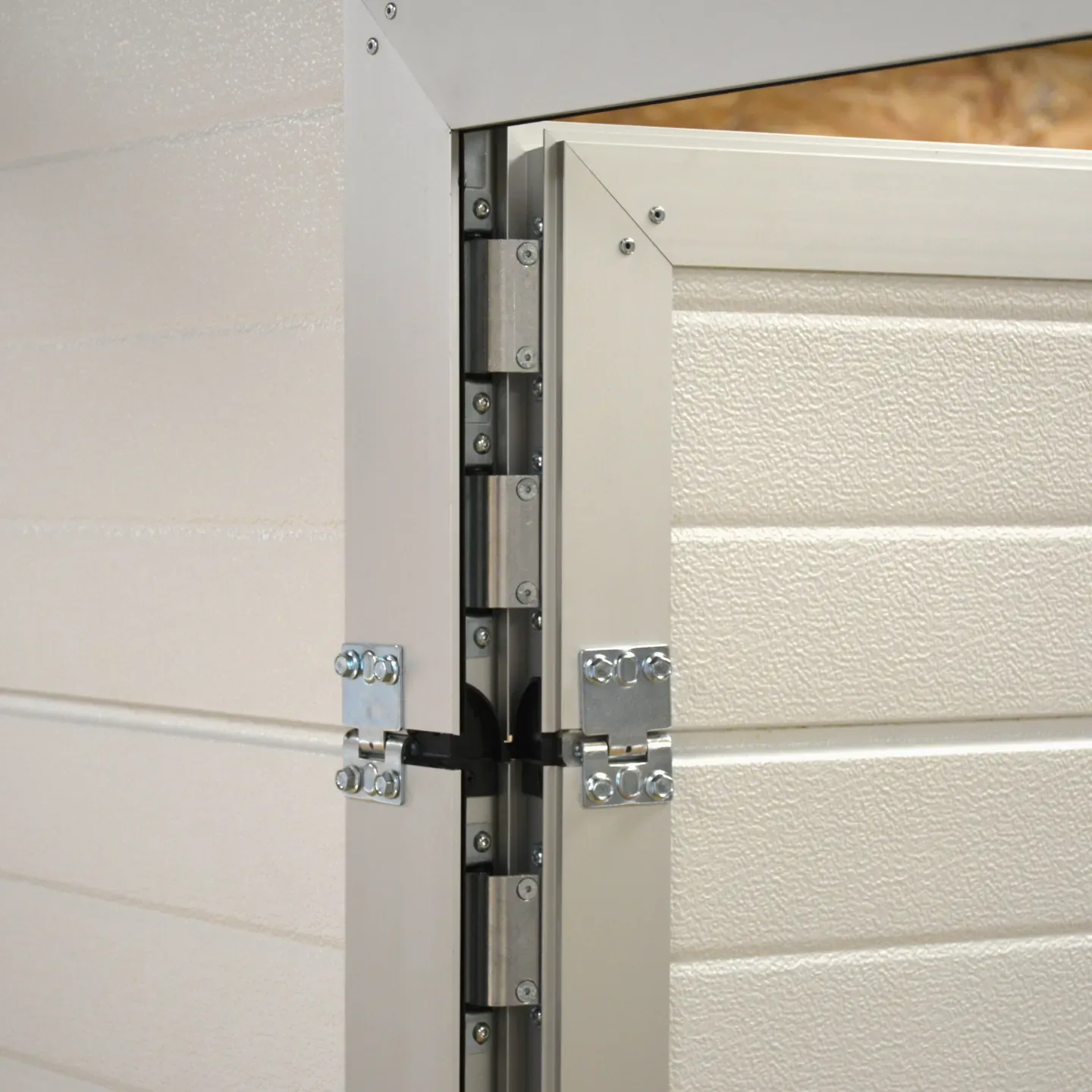 Close-up of the concealed hinge where the built-in door meets the panel