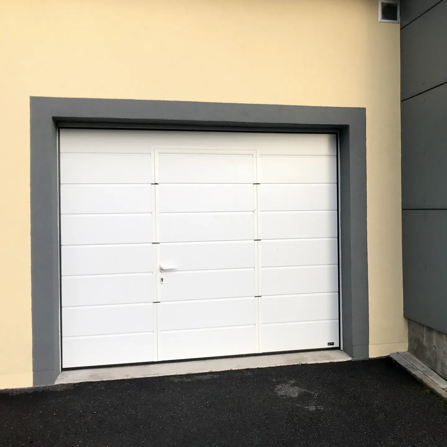 Garage door with a built-in door, viewed from inside the garage